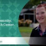 Woman with red hair pulled into a ponytail, wearing a checkered button up and a navy blue sweater promotes the My Community, My Health Center campaign for the Community Health Centers of Benton & Linn Counties (CHC).