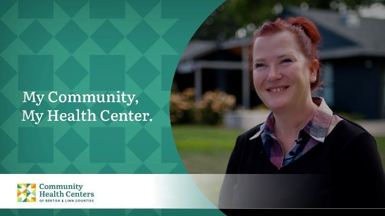 Woman with red hair pulled into a ponytail, wearing a checkered button up and a navy blue sweater promotes the My Community, My Health Center campaign for the Community Health Centers of Benton & Linn Counties (CHC).