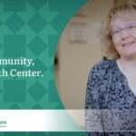 Woman with short blonde hair wearing glasses and a blue floral top promotes the My Community, My Health Center campaign for the Community Health Centers of Benton & Linn Counties (CHC).