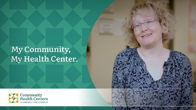 Woman with short blonde hair wearing glasses and a blue floral top promotes the My Community, My Health Center campaign for the Community Health Centers of Benton & Linn Counties (CHC).