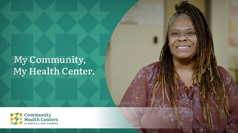 Woman with dark skin and long brown hair worn in braids wearing a floral blouse promotes the My Community, My Health Center campaign for the Community Health Centers of Benton & Linn Counties (CHC).